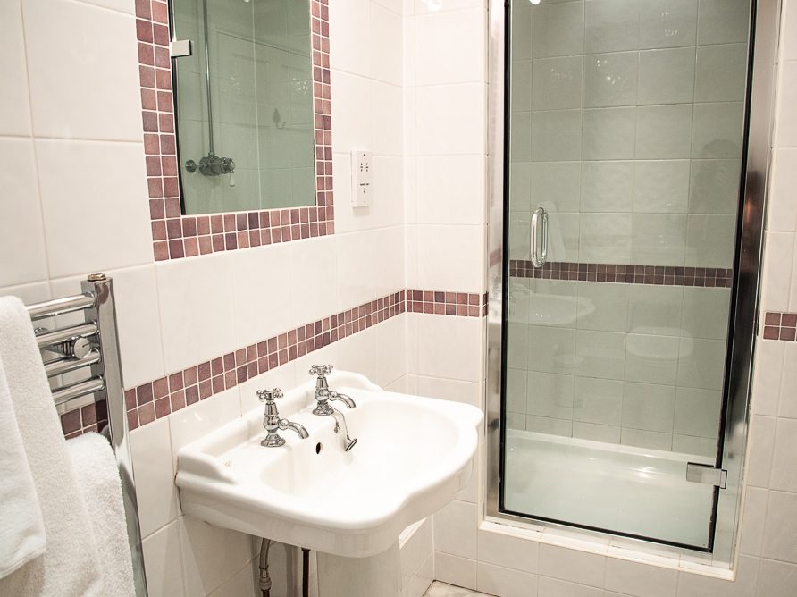 Guest room with en suite bathroom in the Rushop Hall farmhouse