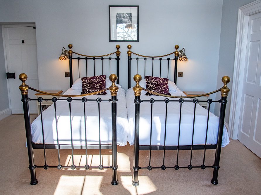 Guest room with en suite bathroom in the Rushop Hall farmhouse